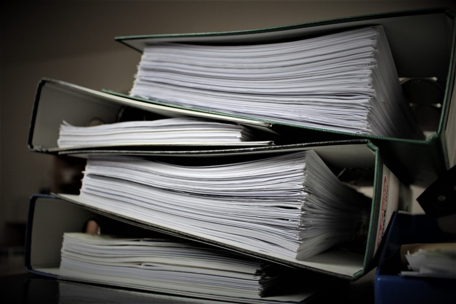 A stack of papers on a desk.