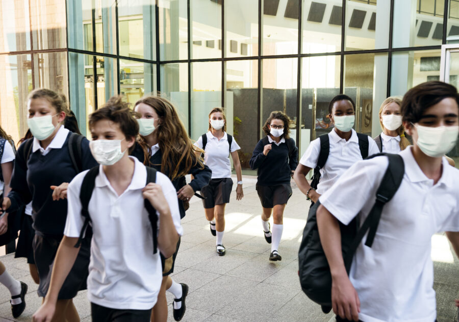 High school students wearing masks and walking