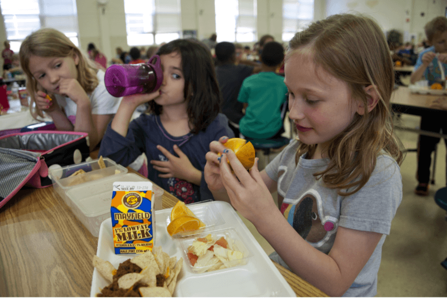 Children enjoying lunch in a school cafeteria.